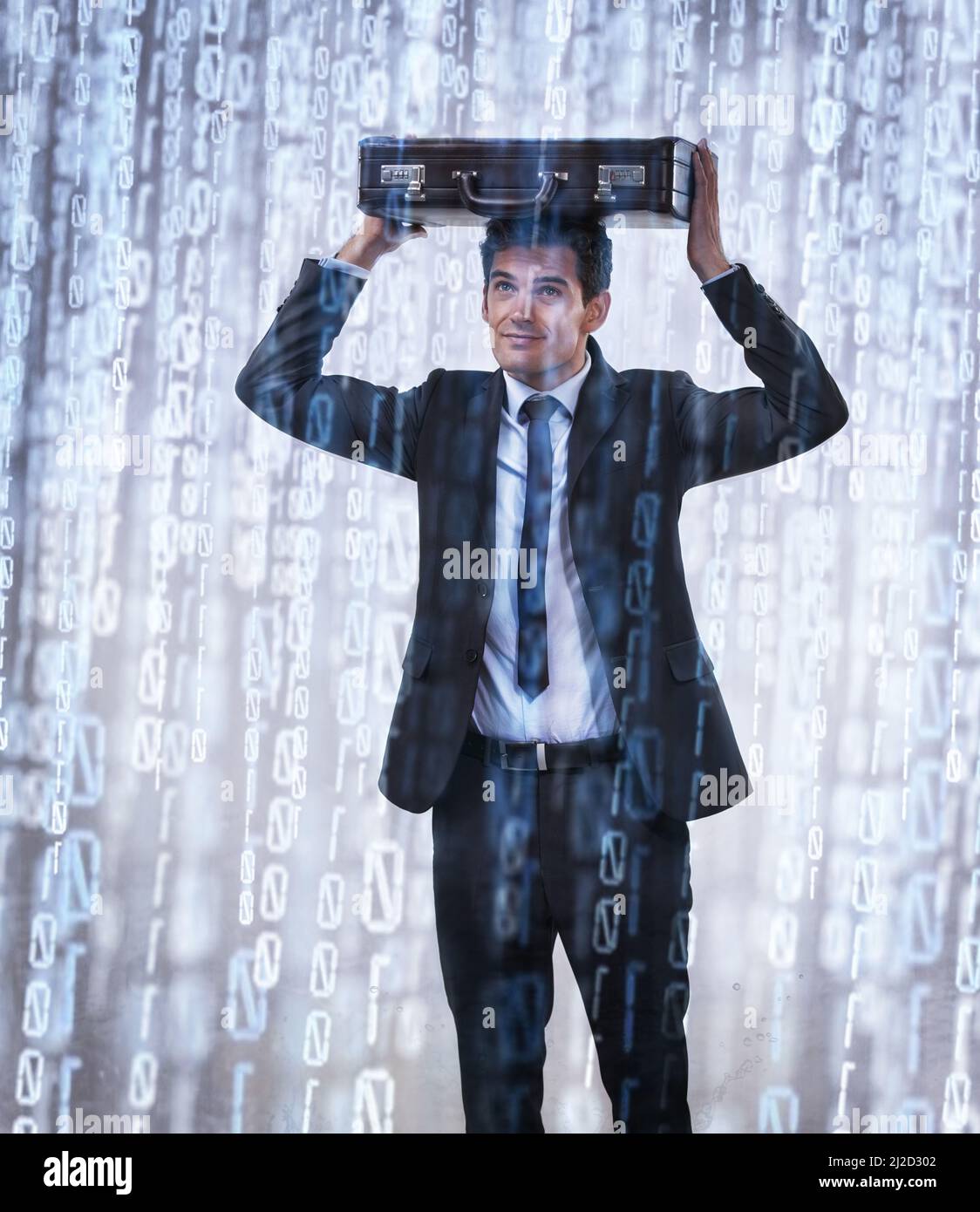 Binary downpour. Studio concept shot of a businessman being rained on by binary code. Stock Photo