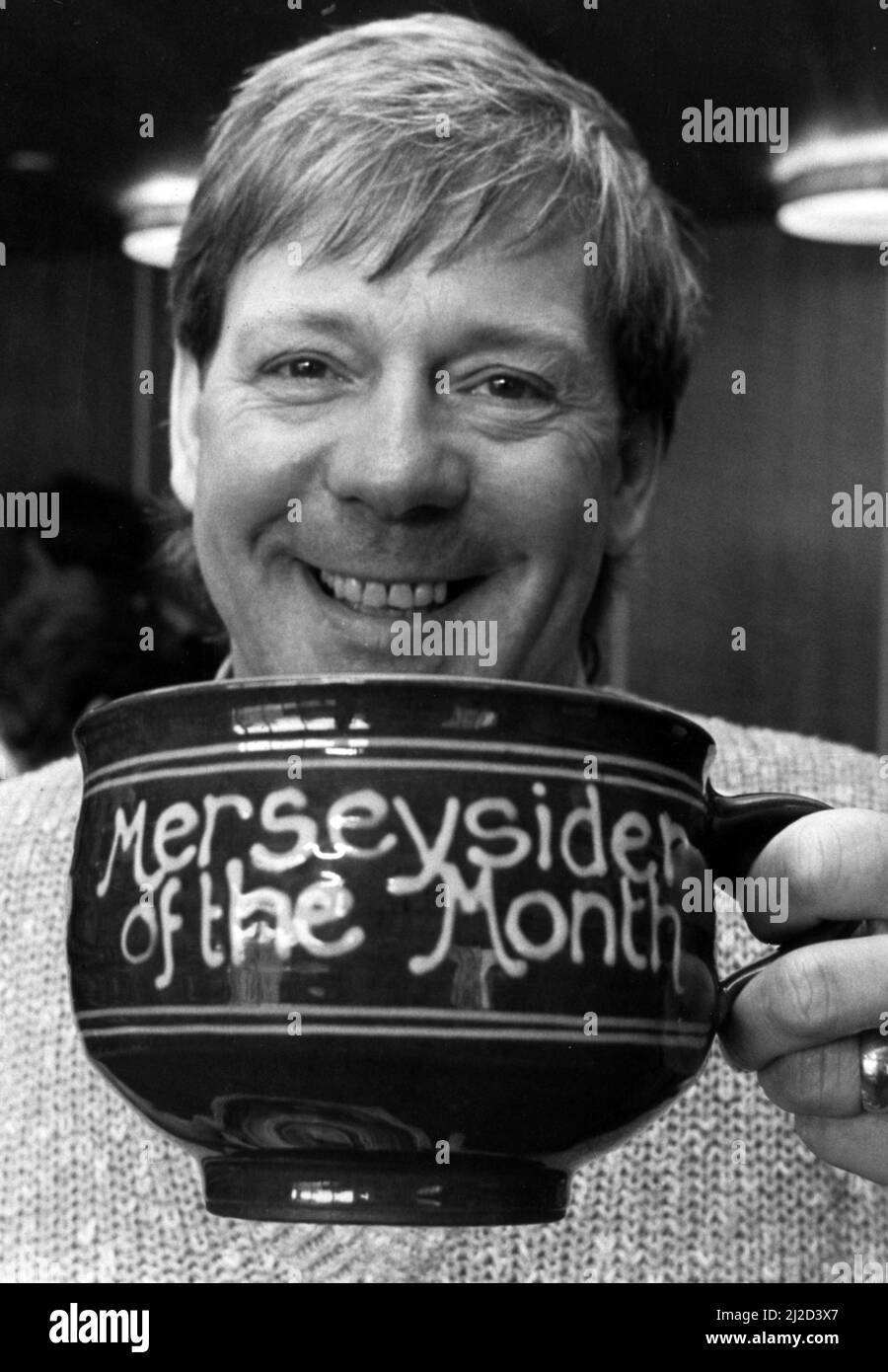 Billy Butler raises a smile and a cup of tea for the Merseyside of the Month competition. 19th April 1985. Stock Photo