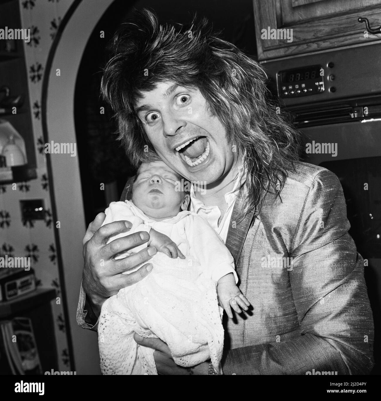 Ozzy Osbourne, former lead singer of Black Sabbath, pictured at home two weeks after the birth of his baby boy Jack.25th November 1985. Stock Photo