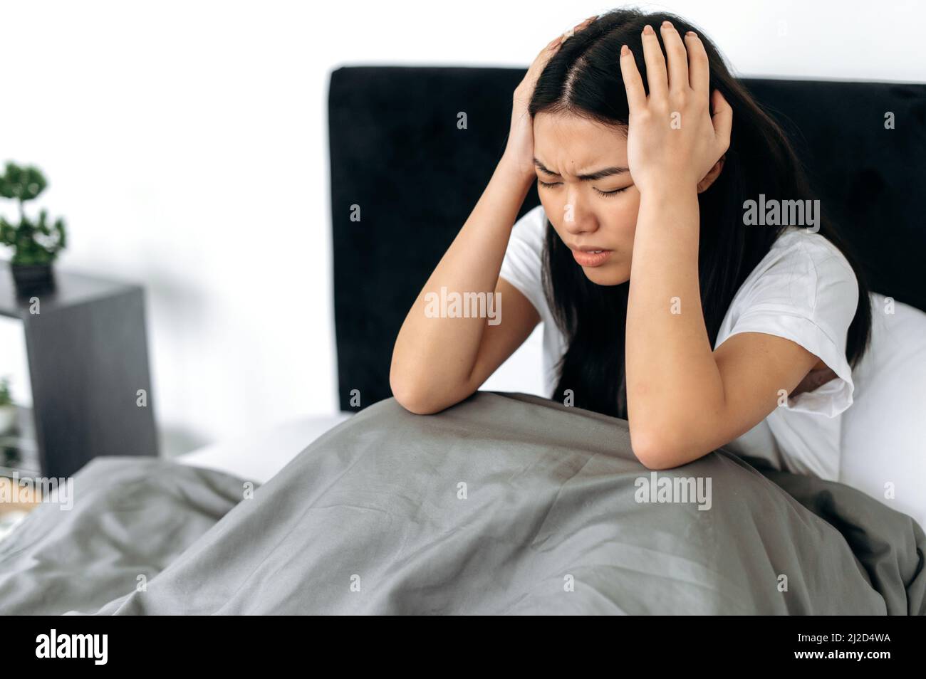 Worried young asian girl bed hi-res stock photography and images - Alamy