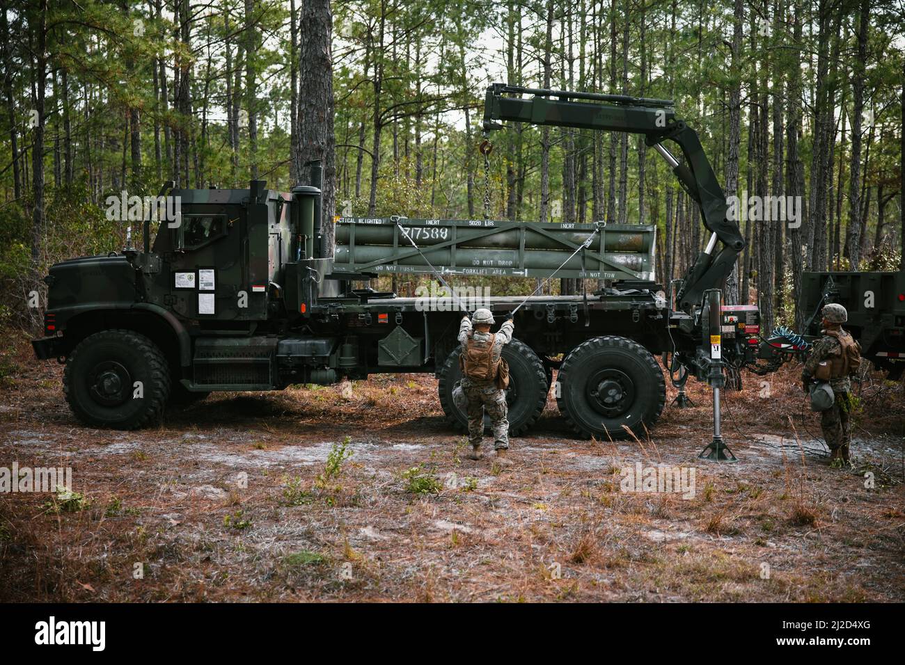 U.S. Marines with 2d Combat Engineer Battalion, 2d Marine Division, load a reduced range practice rocket during Exercise Rolling Thunder 22-2 at Camp Lejeune, North Carolina, March 29, 2022. The Marines utilized the newly-fielded equipment gaining proficiency in constructing combat expedient roads and providing obstacle clearance for moving troops and logistics throughout a contested environment. (U.S. Marine Corps photo by Sgt. Corey Mathews) Stock Photo