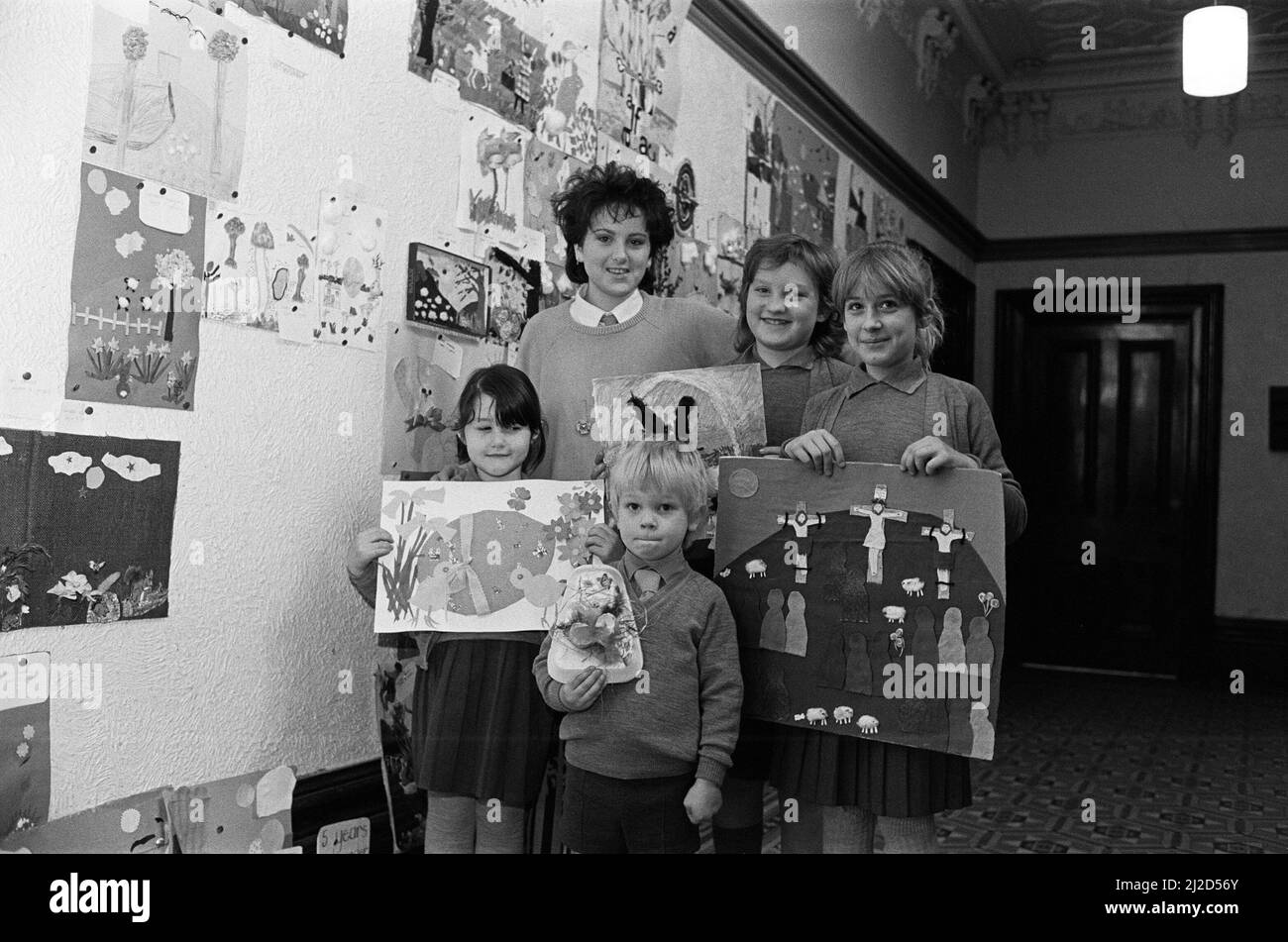 Mount School pupils show off their winning entries in the school's collage competition. They are (from left): Amy Lodge, Iain Driver, Tamara Powell and Rebecca Armitage. Behind them is Marie Louise Harrison, a fashion design student who judged and presented the prizes of chocolate Easter eggs. All the schoolchildren made pictures either depicting an Easter or Spring scene, which were judged in four age groups. 3rd April 1985. Stock Photo