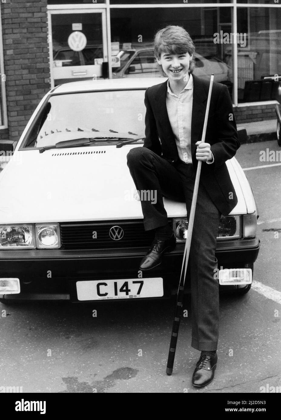 Stephen Hendry poses with his Volkswagen Scirocco GT, the 120mph car was bought in a special deal with a Glasgow firm.At 16 the up and coming star of Scottish snooker is too young to drive! its' a bit of a nuisance said Stephen the youngest ever professional snooker player. 10th January 1985 Stock Photo