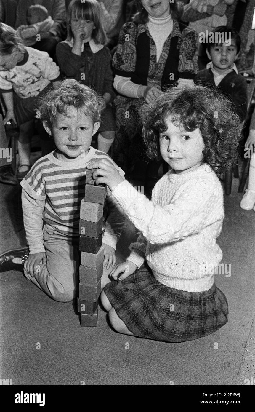 Helping raise money for new toys at their playgroup are three-year-old Simon Gerrard and four-year-old Natalie CHadwick. The children were among about 50 children from Salendine Nook Baptist Playgroup who took part in a sponsored brick build. The two-day event in the church hall raised 200 pounds. 29th April 1986. Stock Photo