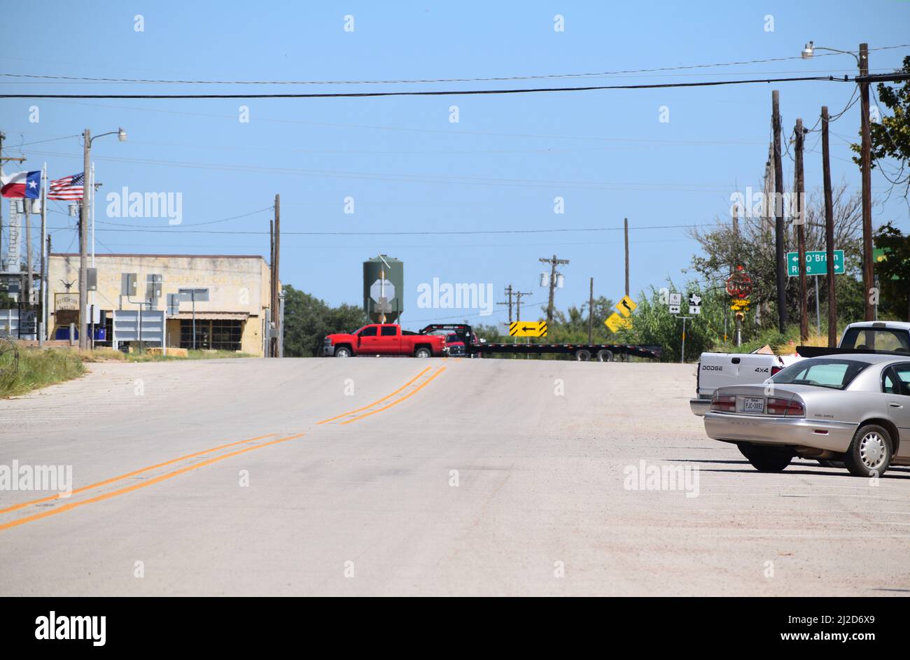 A red pick up truck and trailer driving past the town of Rochester