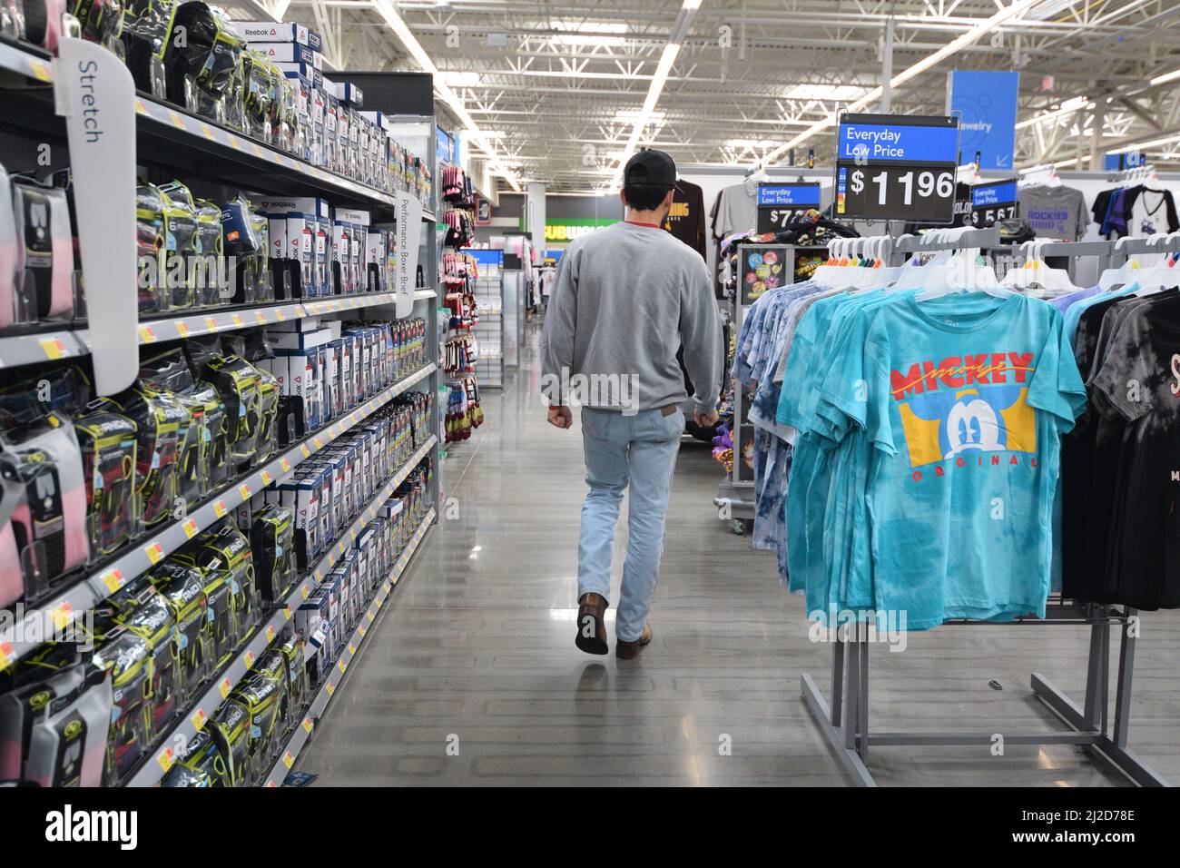 Gen Z man walking through an aisle of a Walmart store in Cheyenne Wyoming - August 2021 Stock Photo