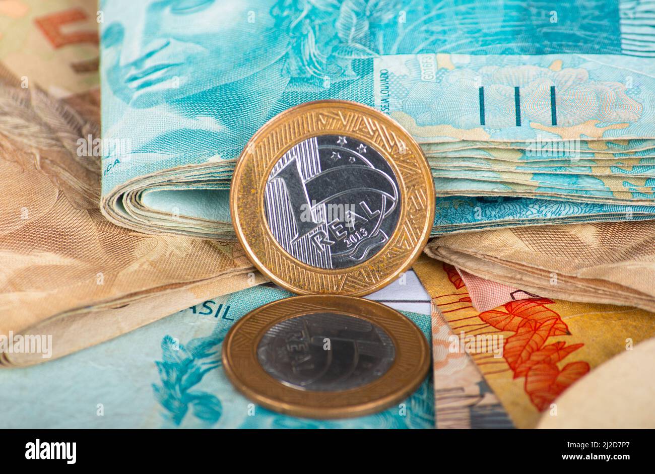 Finance concept. Brazilian money banknotes and coins. one real coin ...