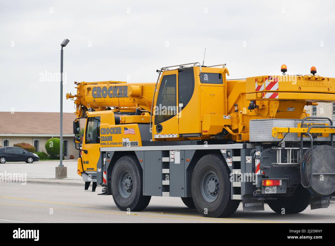 A Liebherr brand mobile crane driving on Story Rd. from Crocker Crane