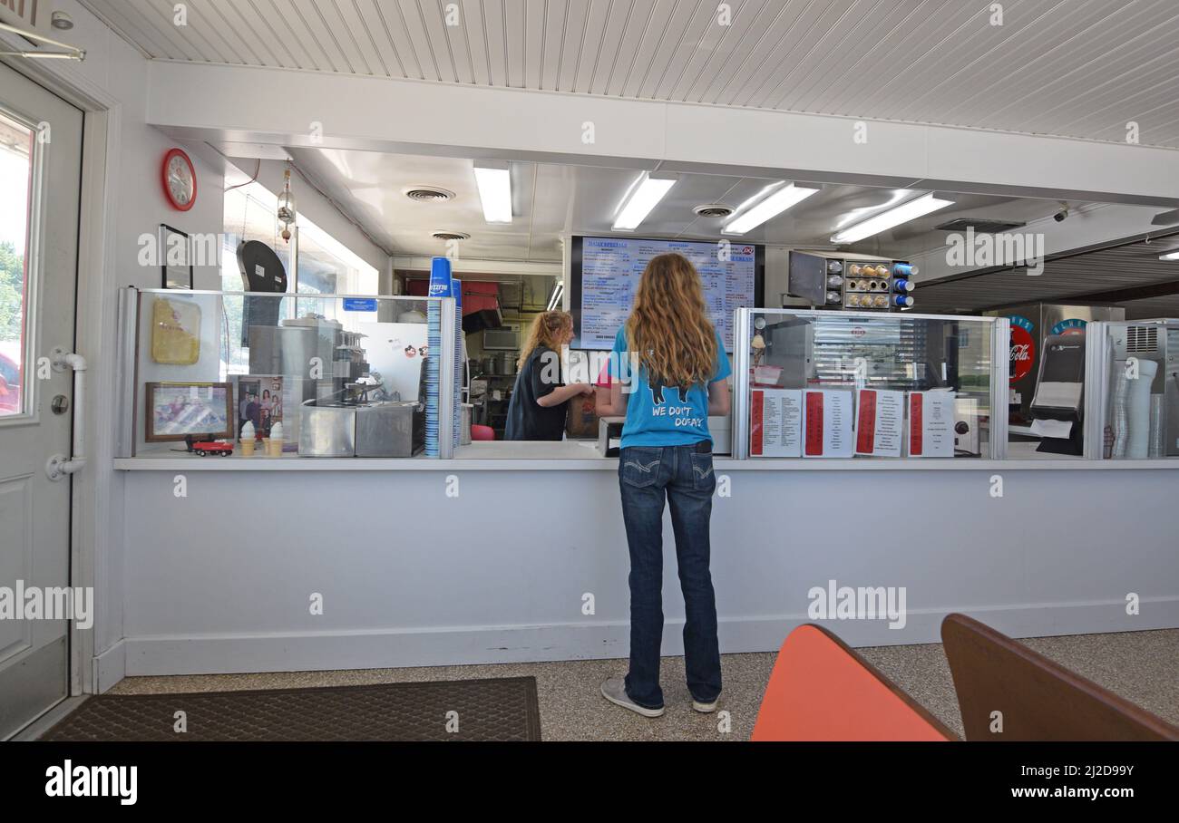 A young woman customer places her order at the counter of a Dairy Queen restaurant in Cissna