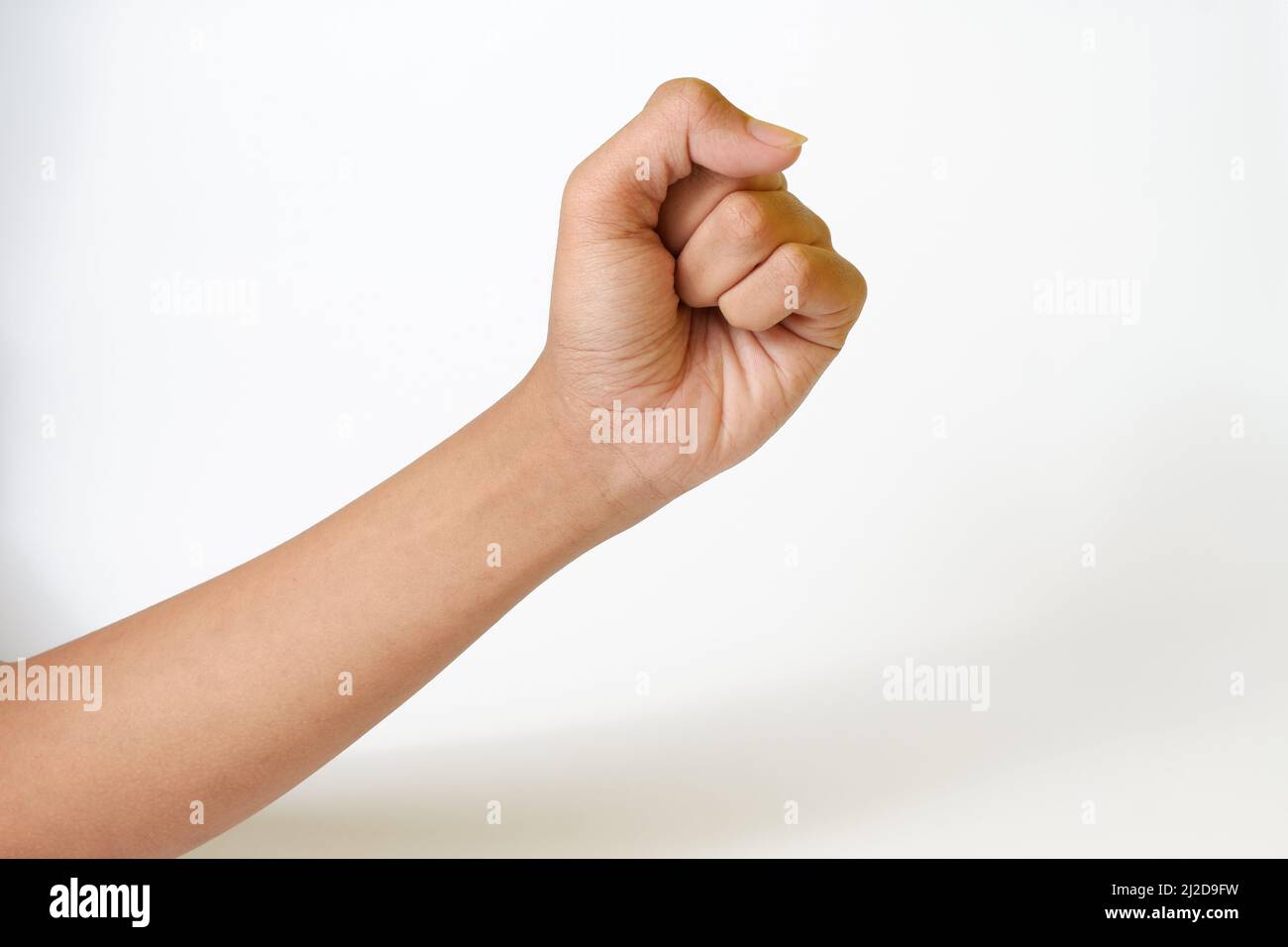 An adult Caucasian female hand showing fist gesture isolated on a white ...