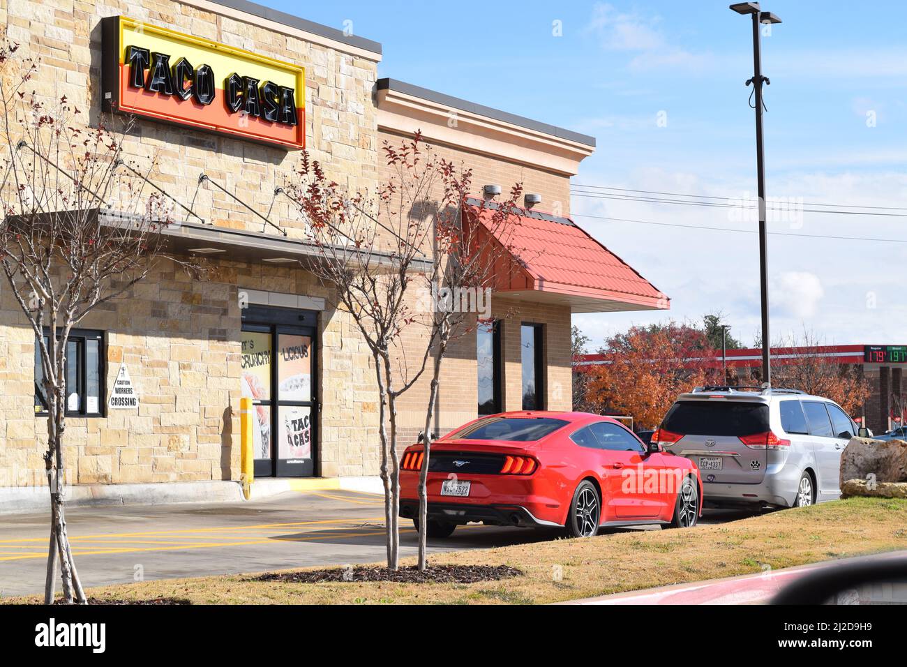 Cars parked next to a Taco Casa drive thru in Granbury, TX Stock Photo