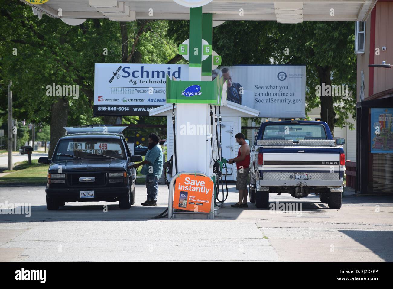 Customers pumping gas at the BP gas station in Cissna Park, Illinois