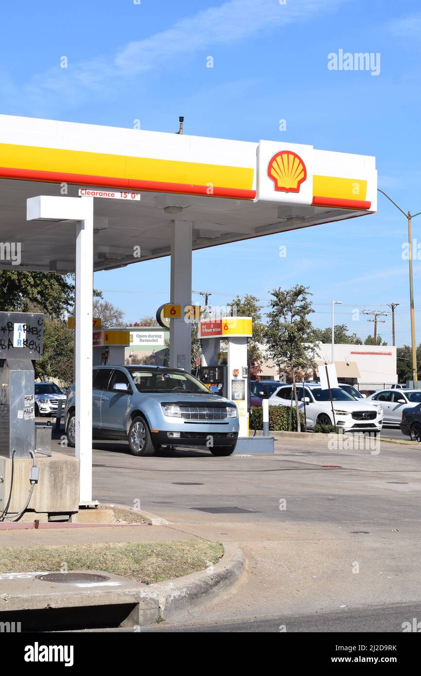 Customer pumping gas at a Shell gas station in Dallas, TX Stock Photo