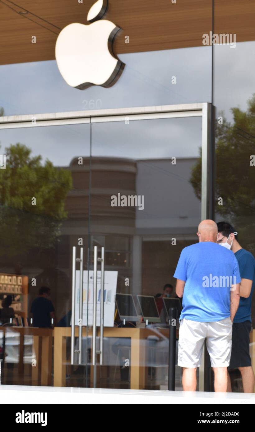 Two men standing outside an Apple Store in Southlake Town Square; Southlake, TX Stock Photo