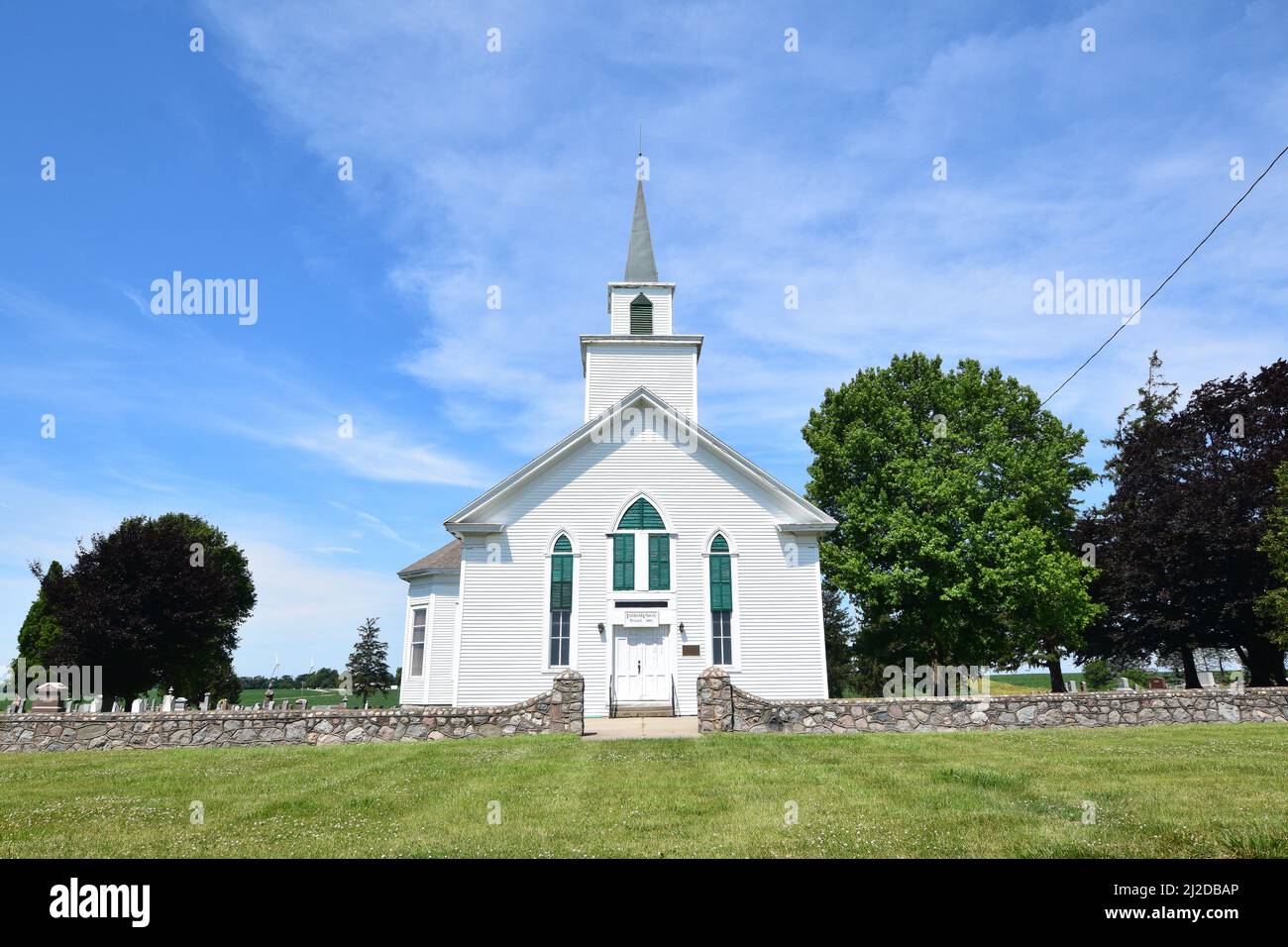 A small white church under a blue sky in rural east central Illinois; Fairfield Church; north of Newman, Illinois Stock Photo