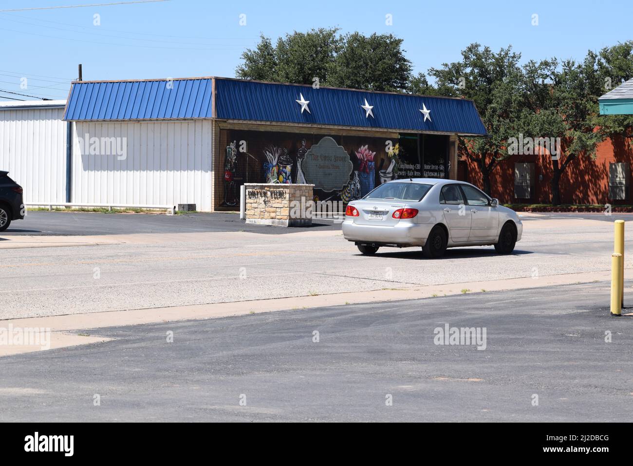 Silver 2004 Toyota Corolla driving down a street in Haskell Texas - August 2021 Stock Photo