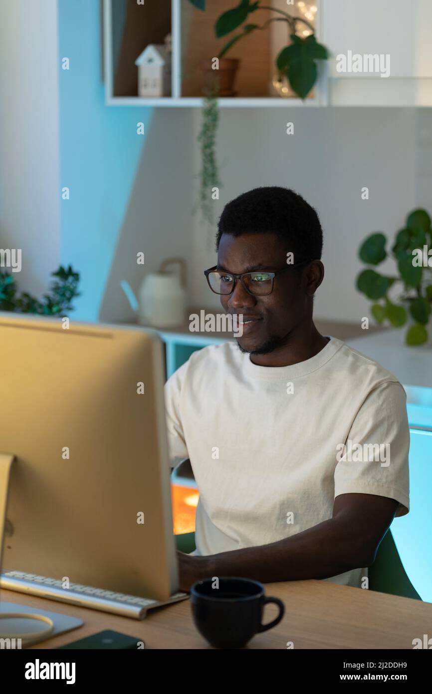 Thoughtful web developer work on computer, programmer trying to find solution for bug in app code Stock Photo