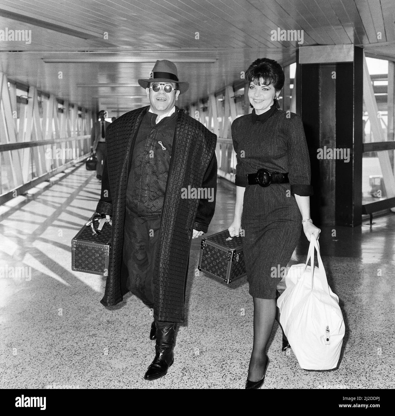 Elton John with his wife Renate arriving from Los Angeles at London
