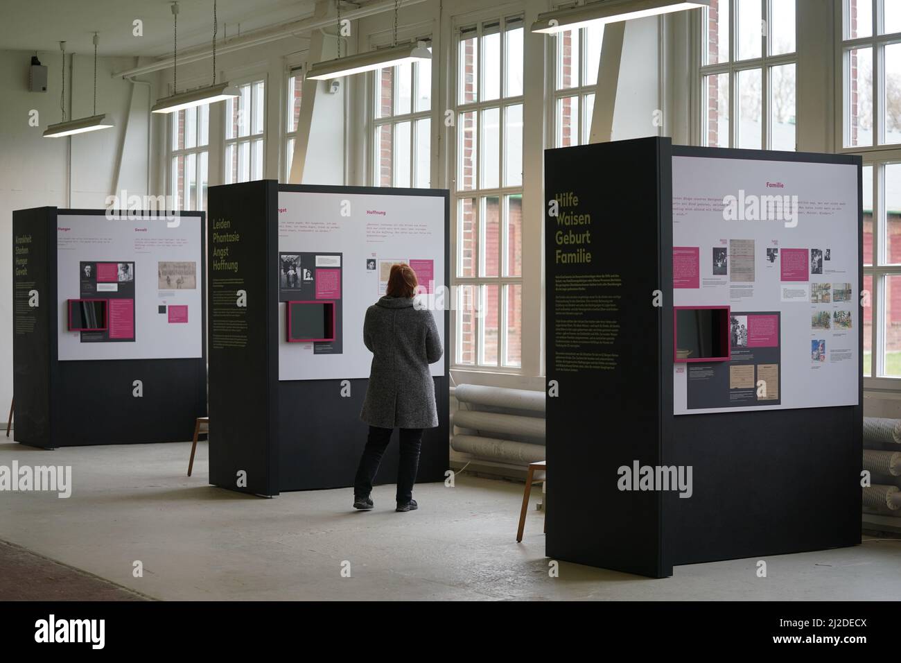 31-march-2022-hamburg-a-staff-member-walks-through-the-exhibition