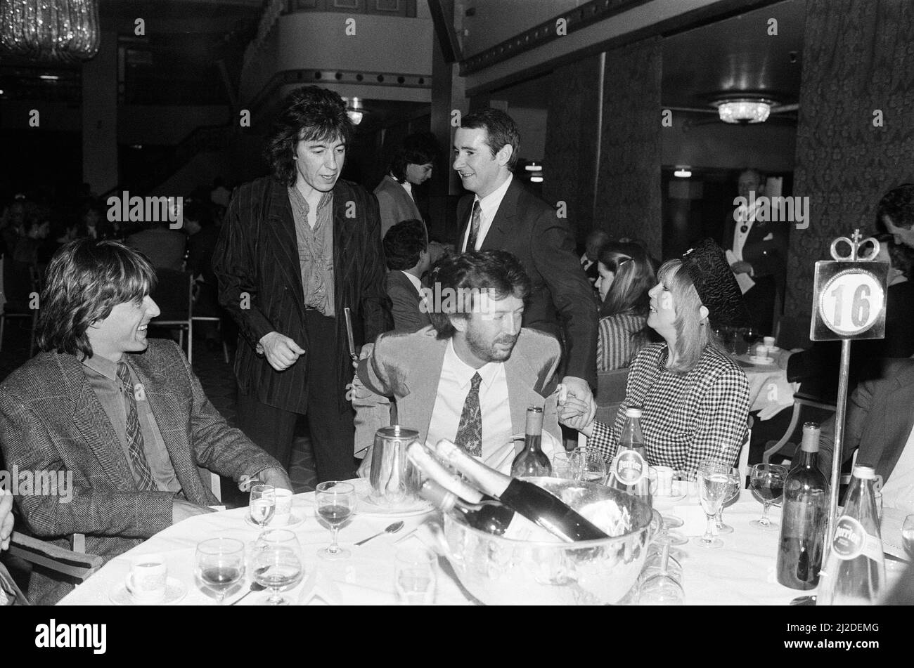 The Ivor Novello Awards at Gorsvenor House, London. Pictured, Bill Wyman, Eric Clapton, Pattie Boyd and John Reid. 7th April 1986. Stock Photo