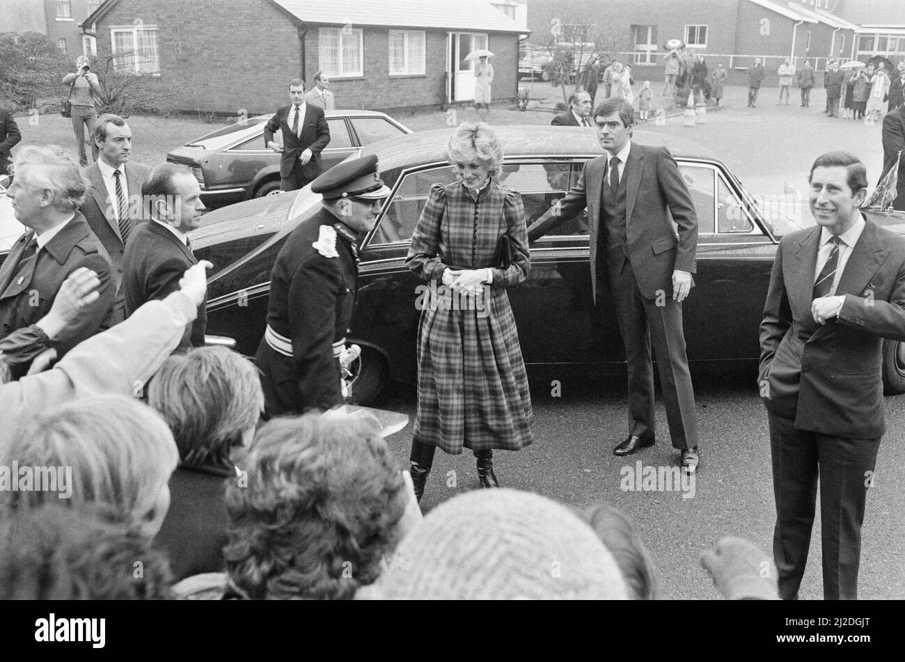 The Prince and Princess of Wales visit Mid Glamorgan in Wales.On this visit, they meet the local well-wishers outside a newly electronics plant.  Picture shows LEFT, STANDING BY THE THE BONNET OF THE CAR Princess Diana's  bodyguard Barry Mannakee wearing a diagonal striped tie and slight pin striped jacket.  Princess Diana, centre wearing tartan, and far right is Prince Charles.  Picture taken 29th January 1985 Stock Photo