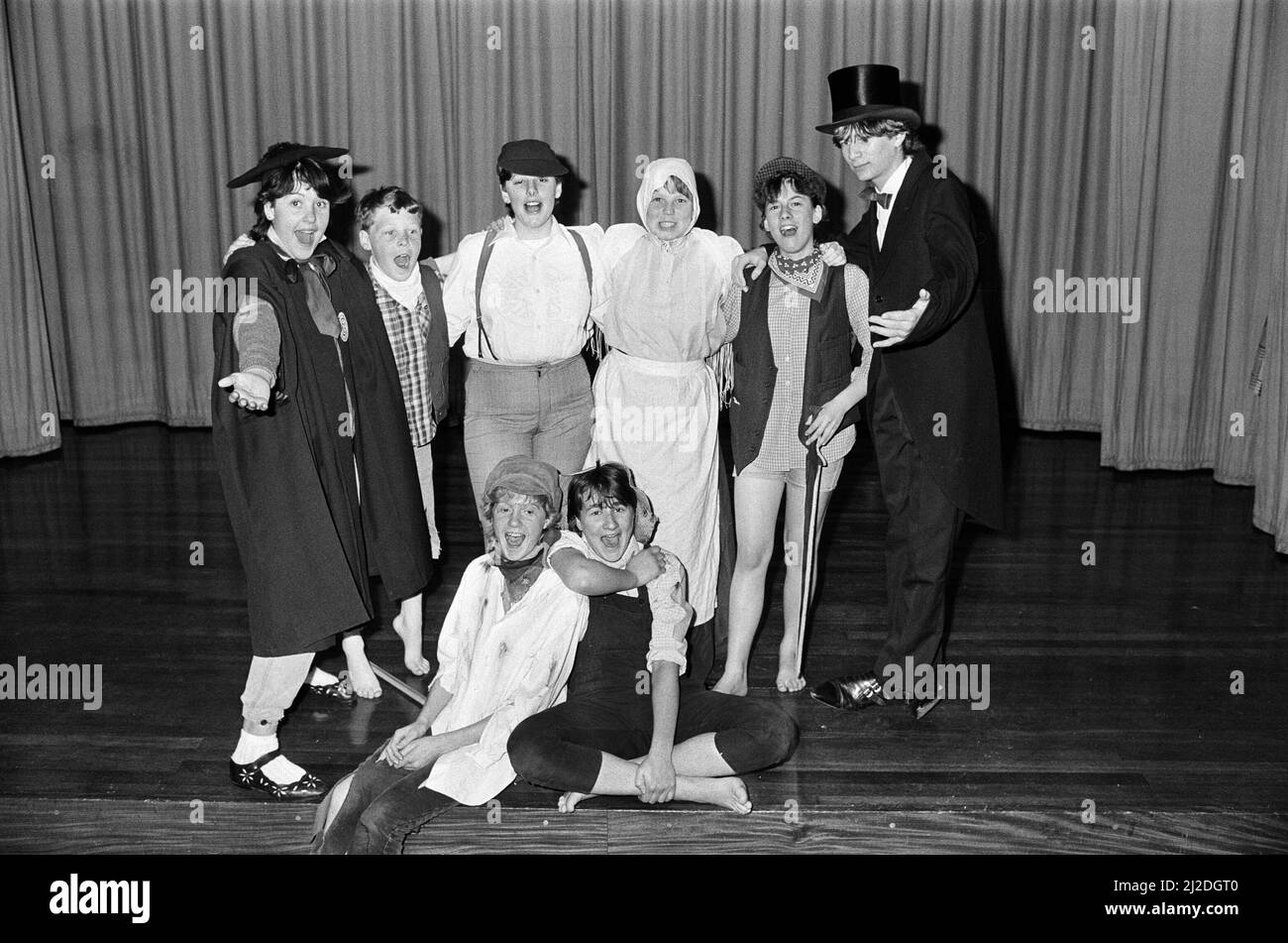 Young Amy Taylor in the guise of Tom Sawyer (front right) and Vanessa Pearson, as Huckleberry Finn (left), take the stage for a two-night production of Tom Sawyer by St John¿ Church drama group, Golcar, at the church school. Also pictured are other members of the 20-strong cast. They are (from left) Anne Phillips, James Taylor, Claire Johnson, Jill Wood, Anne Davies and Tom Taylor. The drama group was specially formed for this production, to raise money for the Martin House children¿ hospice at Boston Spa, near Tadcaster. 7th May 1986. Stock Photo