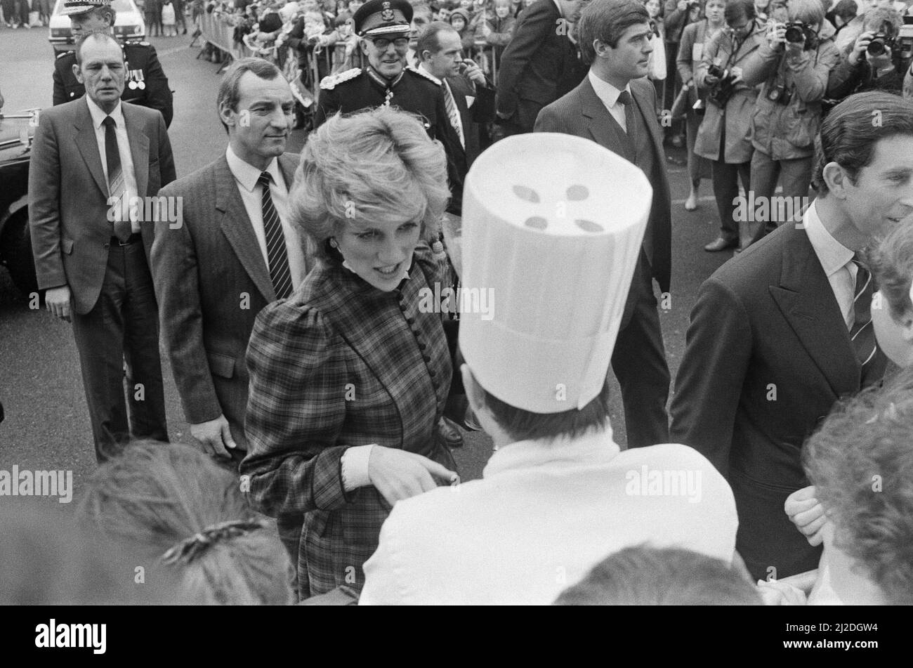 The Prince and Princess of Wales visit Mid Glamorgan in Wales.On this visit, they meet the local well-wishers outside a newly electronics plant.  Picture shows Princess Diana's  bodyguard Barry Mannakee wearing a diagonal striped tie and slight pin striped jacket (standing behind Diana).  Princess Diana, centre wearing tartan, and far right is Prince Charles.  Picture taken 29th January 1985 Stock Photo