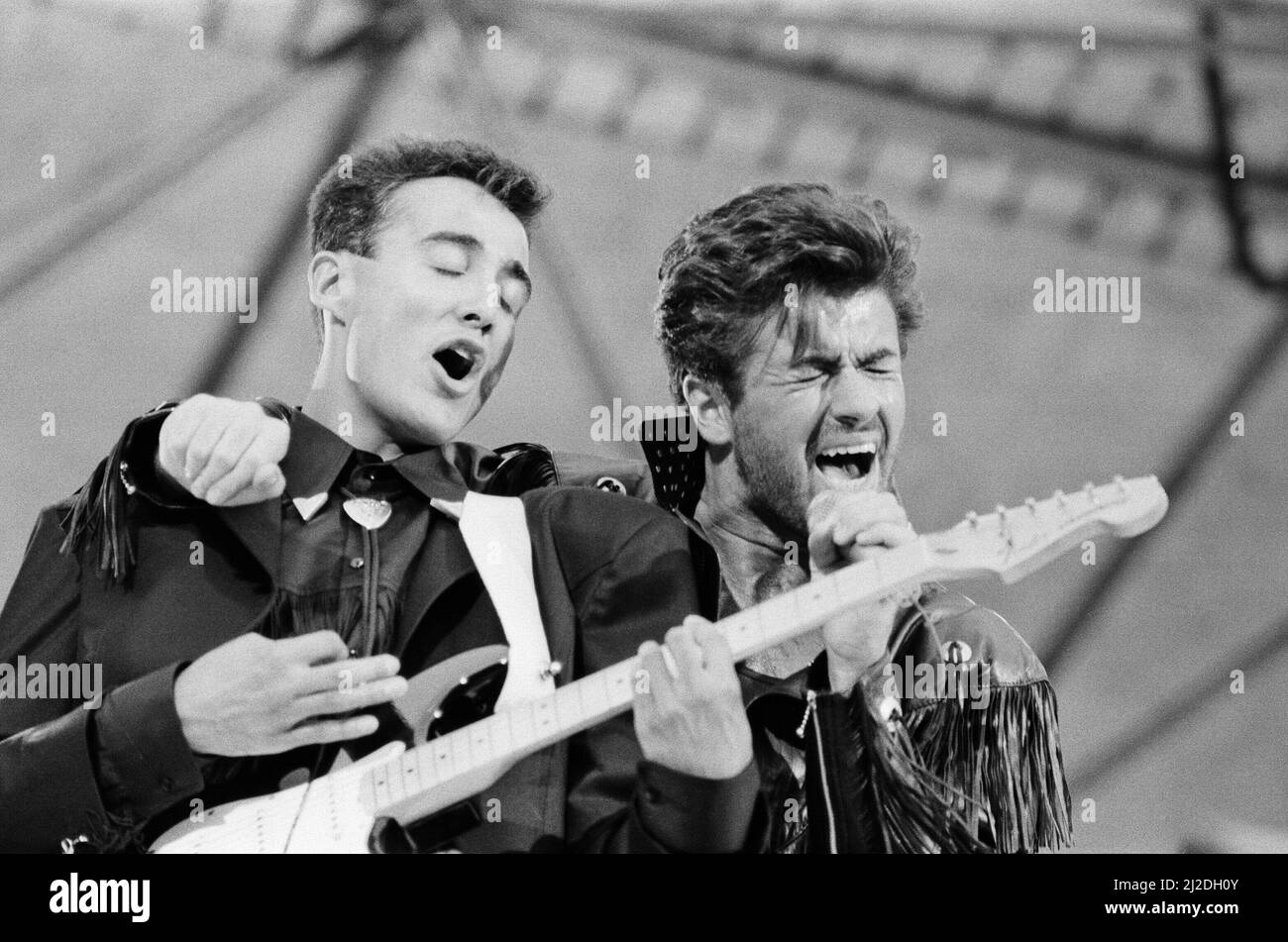 Wham ! The Farewell Concert at Wembley Stadium, London on 28th June 1986. George Michael's real name is Georgios Kyriacos Panayiotou  Wham !,  (singer George Michael, and singer/guitarist Andrew Ridgeley) played their final concert as Wham !, although Andrew joined George as a guest on a few later George Michael solo shows.  Picture taken 28th June 1986 Stock Photo