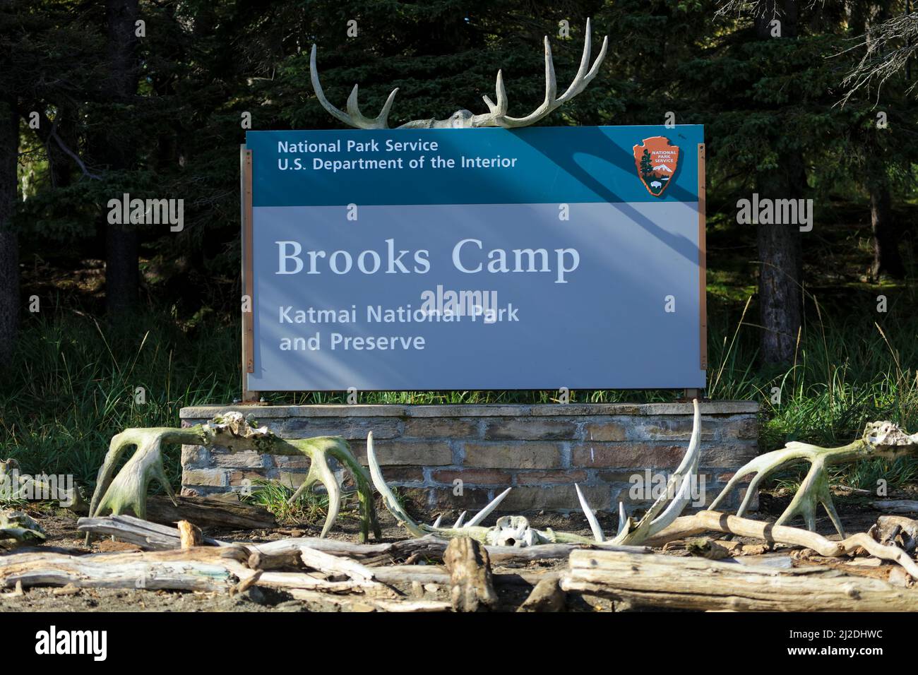 Brooks Camp sign at Katmai National Park, Alaska with giant moose antlers and logs Stock Photo