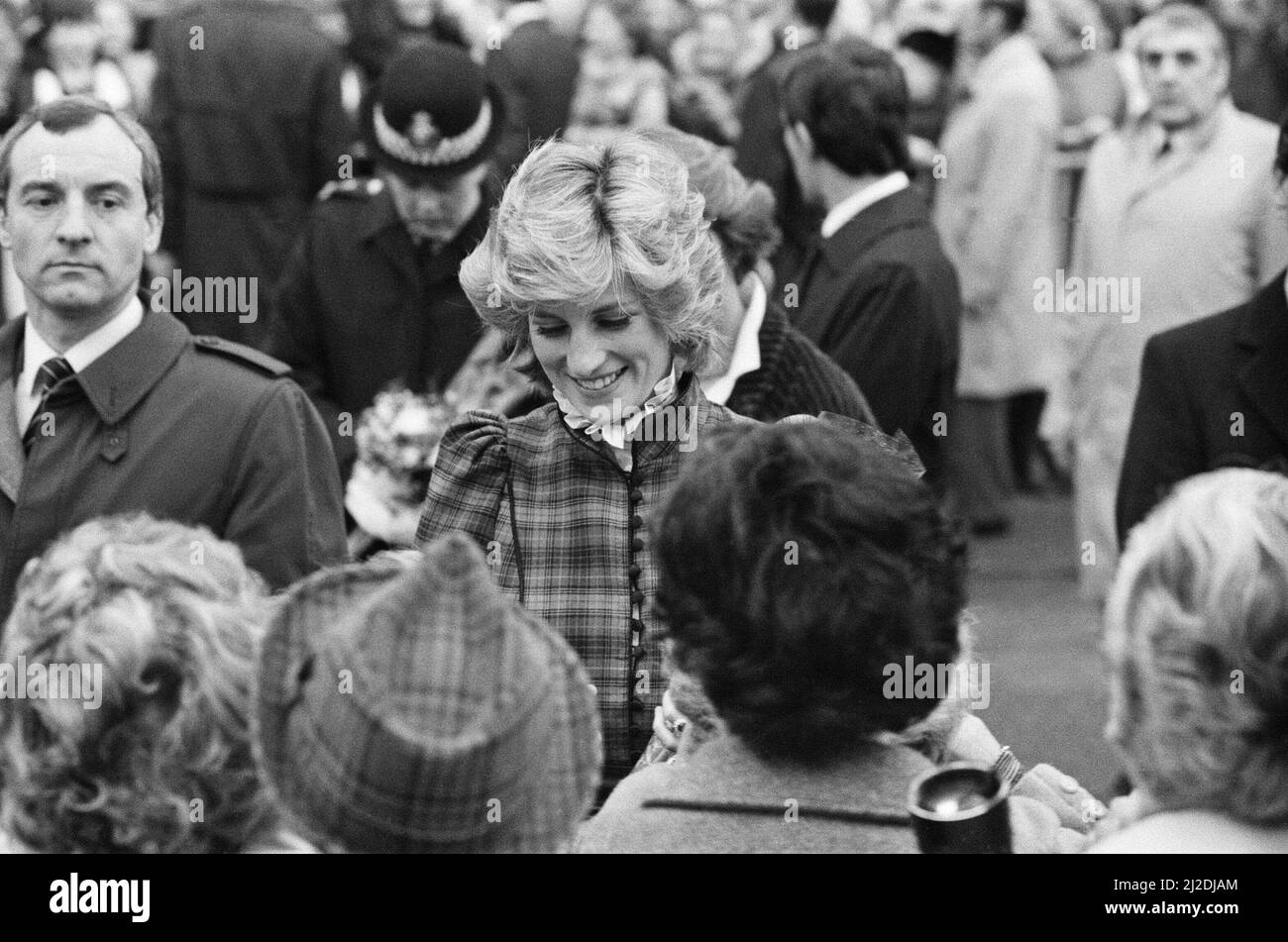 The Prince and Princess of Wales visit Mid Glamorgan in Wales.On this visit, they meet the local well-wishers outside a newly electronics plant.  Picture shows Princess Diana and behind her, her bodyguard Barry Mannakee wearing a diagonal striped tie and overcoat/mac.  See other frames in this set wear Mr Mannakee has taken this coat off and is wearing a slight pin striped suit.  Picture taken 29th January 1985 Stock Photo
