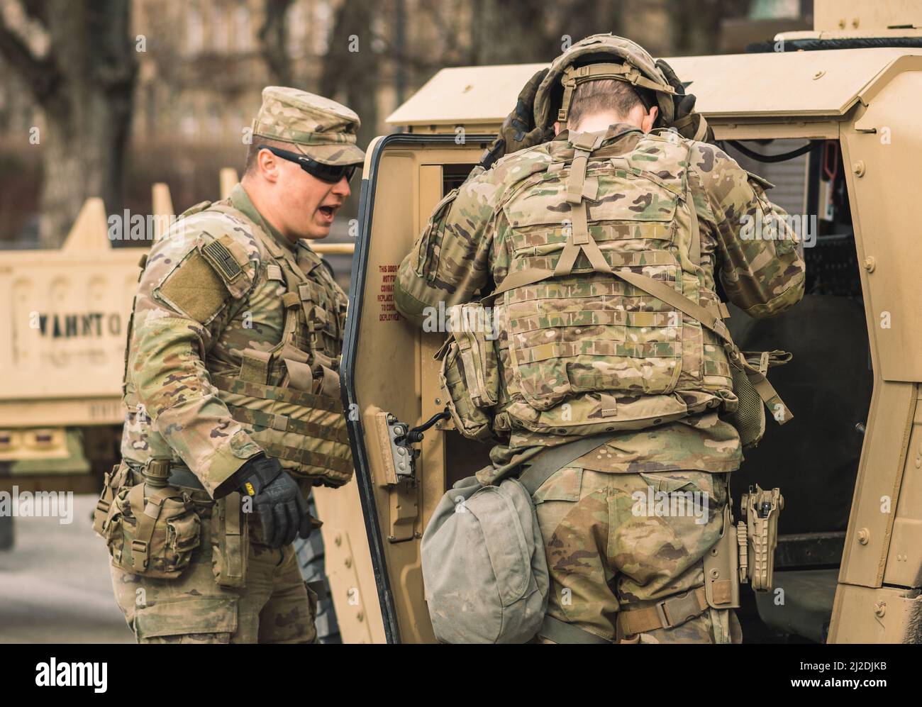 United States Marine Corps soldiers with shotguns or rifles, helmets and armored vehicles humvee, USA or US army troops ready for battle, drills war Stock Photo