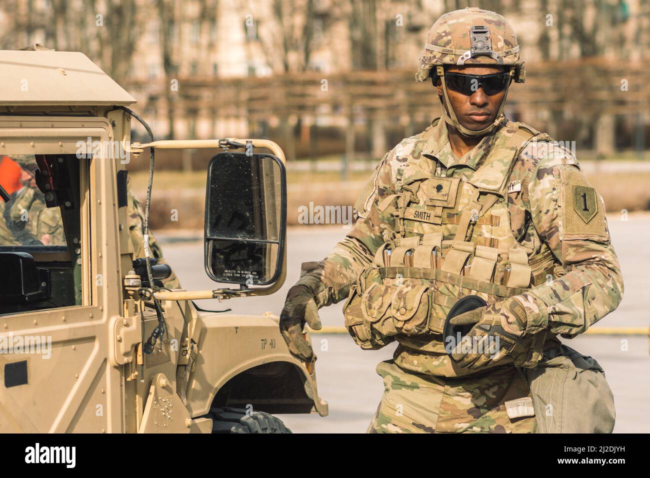 African American United States Marine Corps soldier with sunglasses, shotgun or rifle and armored vehicle humvee, USA or US army troops ready for war Stock Photo