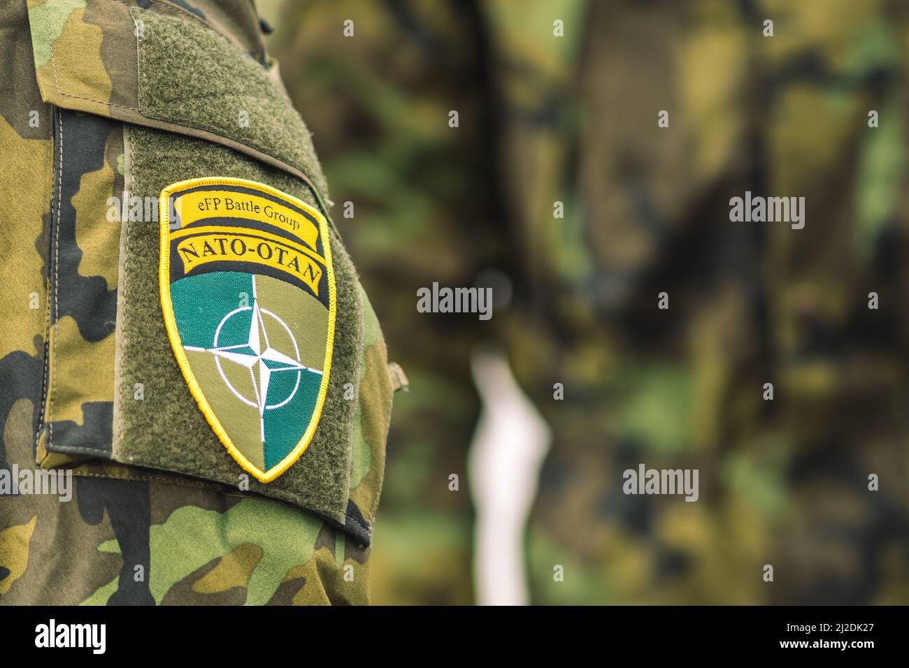 Flag and symbol of NATO on a soldier uniform, NATO force integration unit, close up Stock Photo