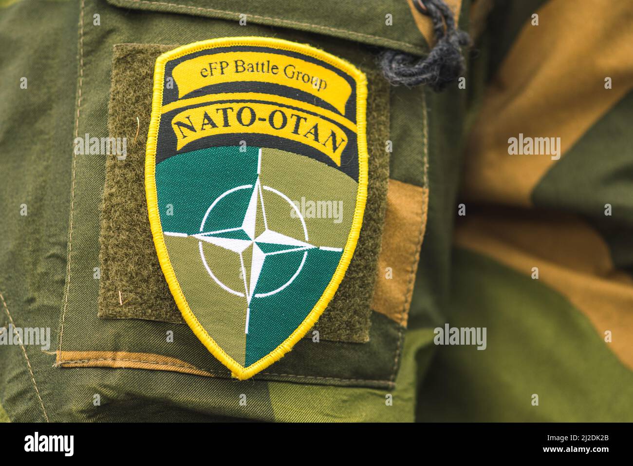 Flag and symbol of NATO on a soldier uniform, NATO force integration unit, close up Stock Photo