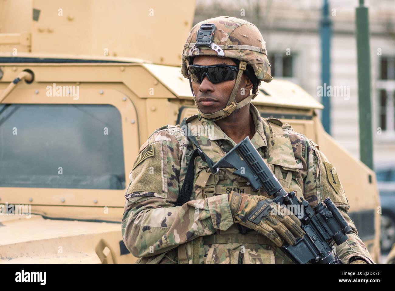 African American United States Marine Corps soldier with sunglasses, shotgun or rifle and armored vehicle humvee, USA or US army troops ready for war Stock Photo