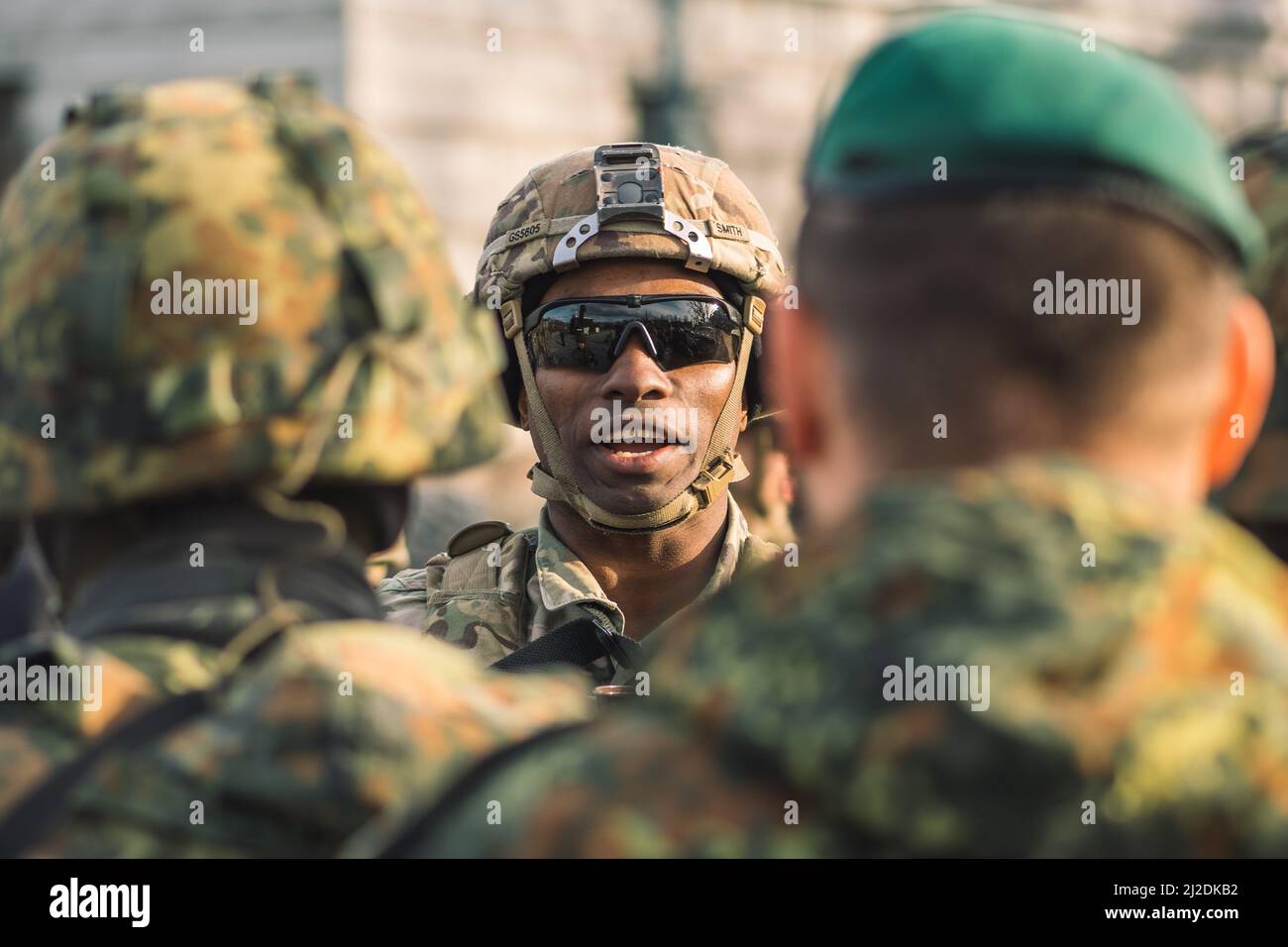 African American United States Marine Corps soldier with sunglasses, shotgun or rifle and armored vehicle humvee, USA or US army troops ready for war Stock Photo