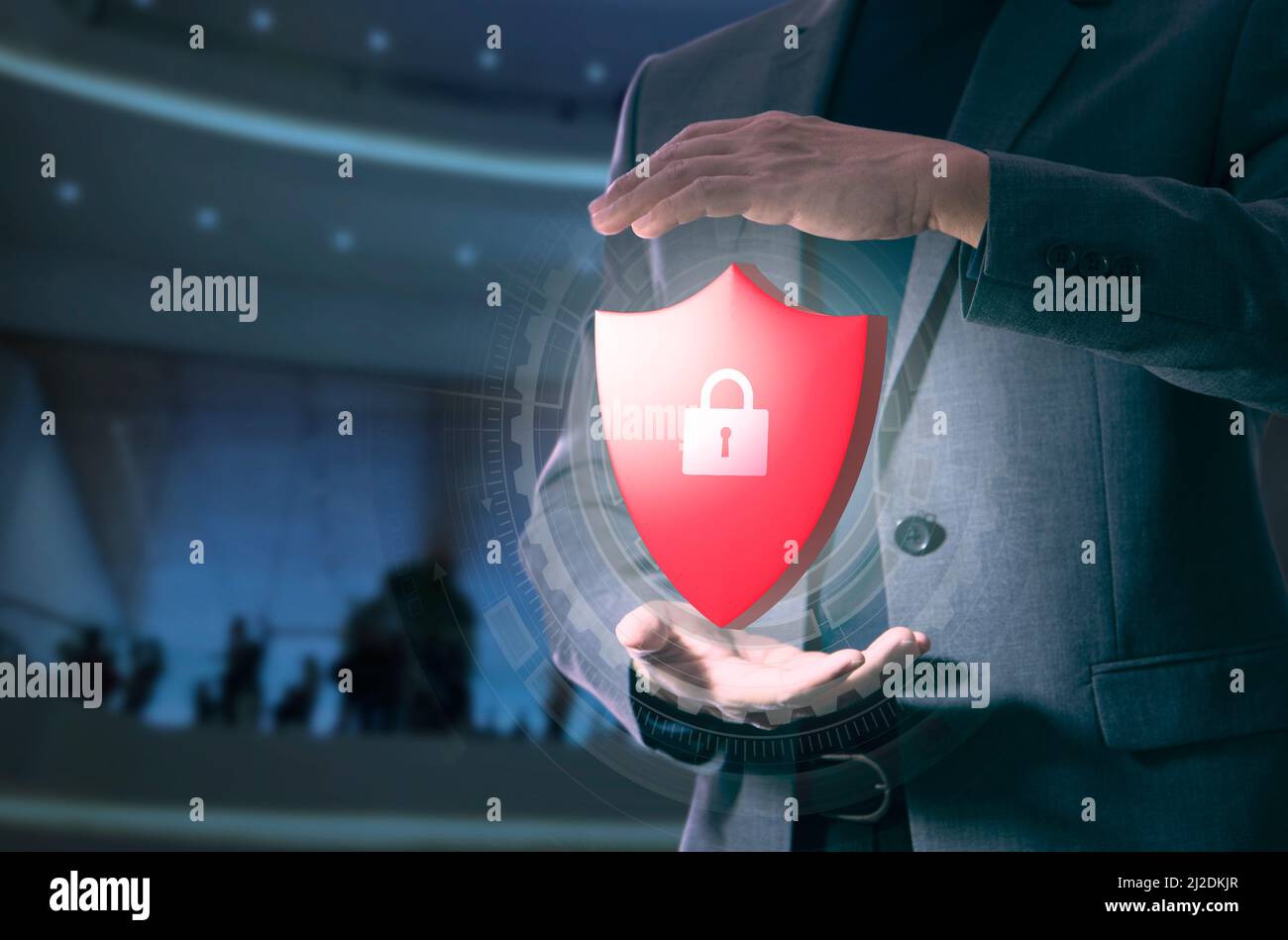 System administrator in gesture of expanding his hands holding a virtual red metal shield with padlock in system security and data protection concept Stock Photo