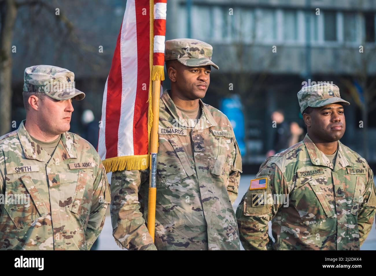 United States Marine Corps soldiers roll up American flag, USA or US army troops ready for drills or war Stock Photo
