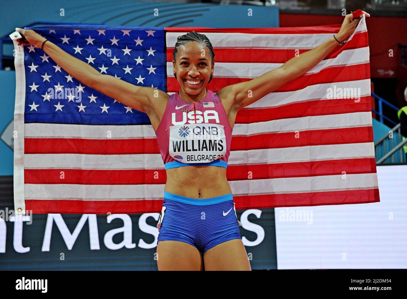 Kendell Williams (USA) poses with United States flag after finishing