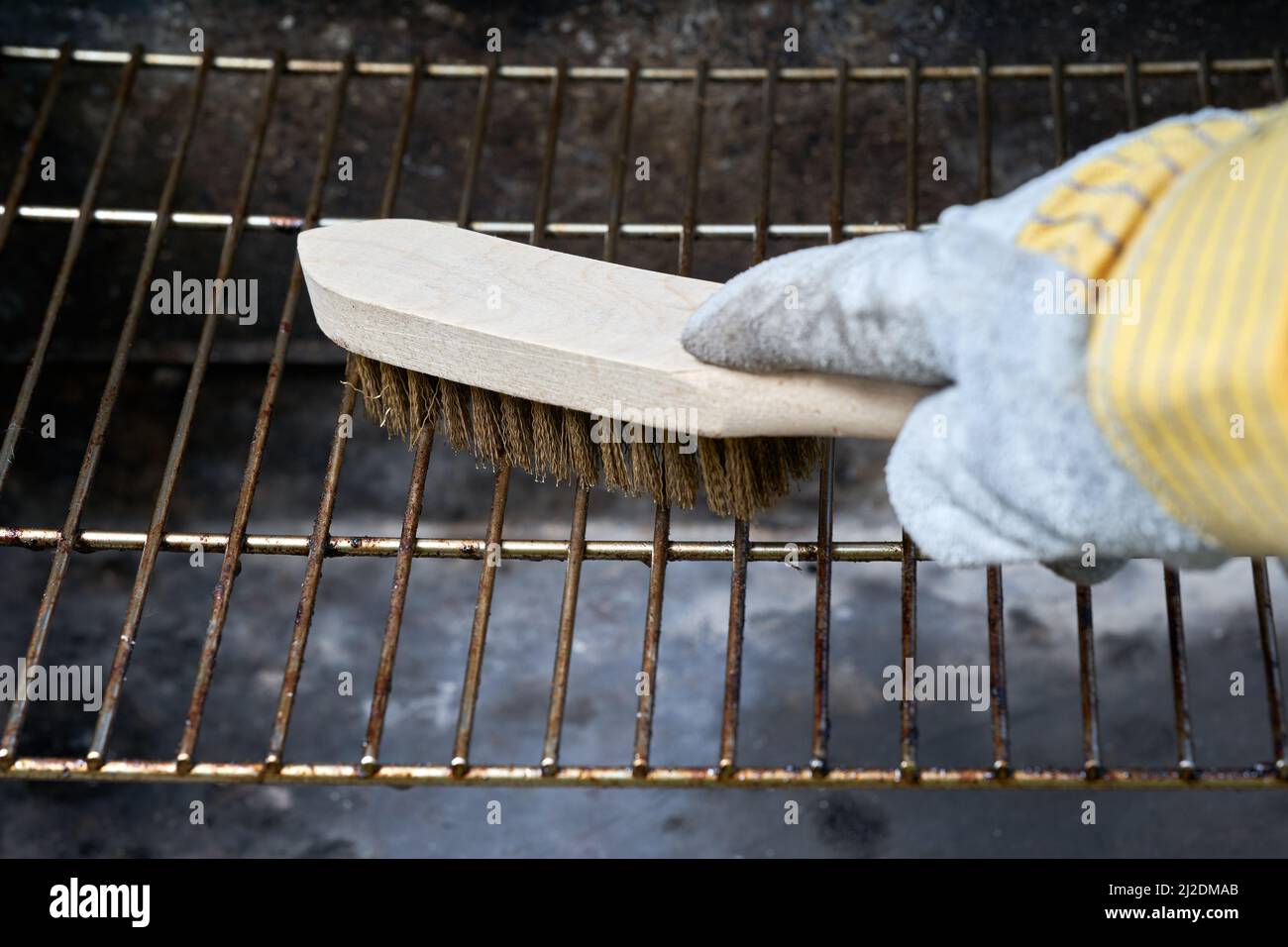 Wooden wire brush cleans dirty barbecue grill rust. Leather protection ...