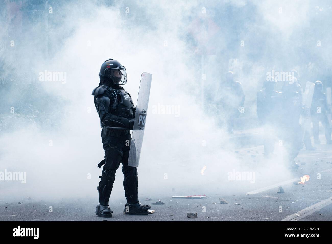 A colombia's riot police officer 'ESMAD' is seen inside a cloud of tear gas as students protested against Colombia's national police and government on March 31, 2022 in Bogota, Colombia. As demonstrators and Colombia's riot police squad 'ESMAD' ended up in clashes in northern Bogota. Photo by: Daniel Romero/Long Visual Press Stock Photo