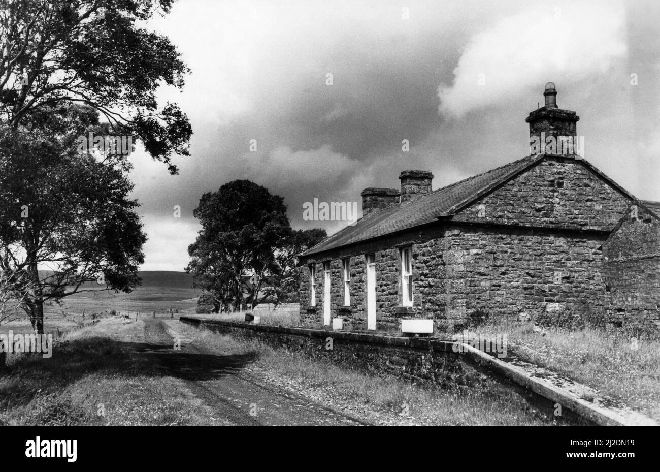 Deadwater Railway Station, on 1st November 1986, now disused, was on the Border Counties Railway which linked the Newcastle and Carlisle Railway, near Hexham, with the Border Union Railway at Riccarton Junction. It was once decreed the loveliest station in England and the line was closed to passengers by British Railways in 1956. Stock Photo