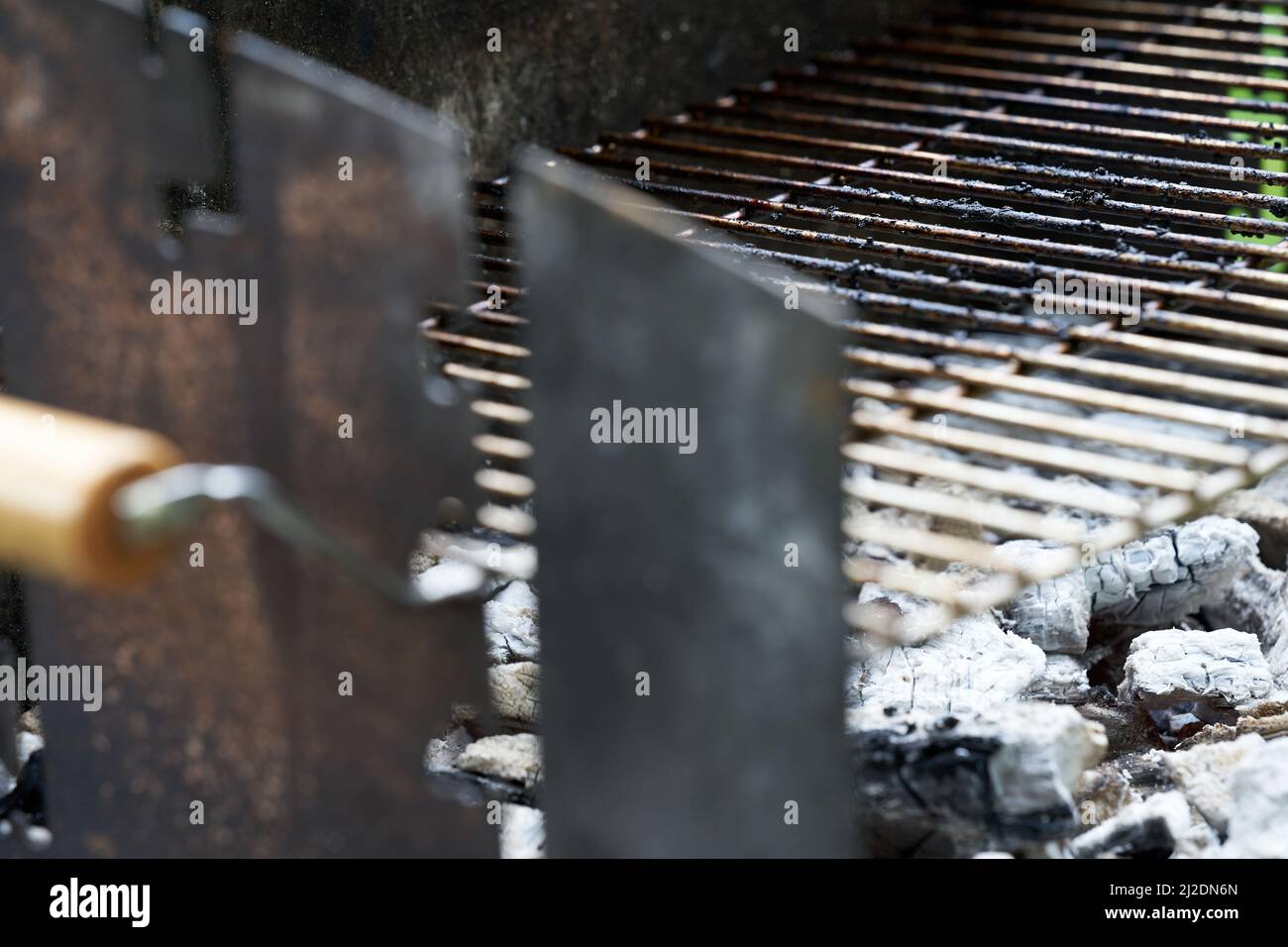 Glowing charcoal and grill grate. Dirty barbecue rust after cooking