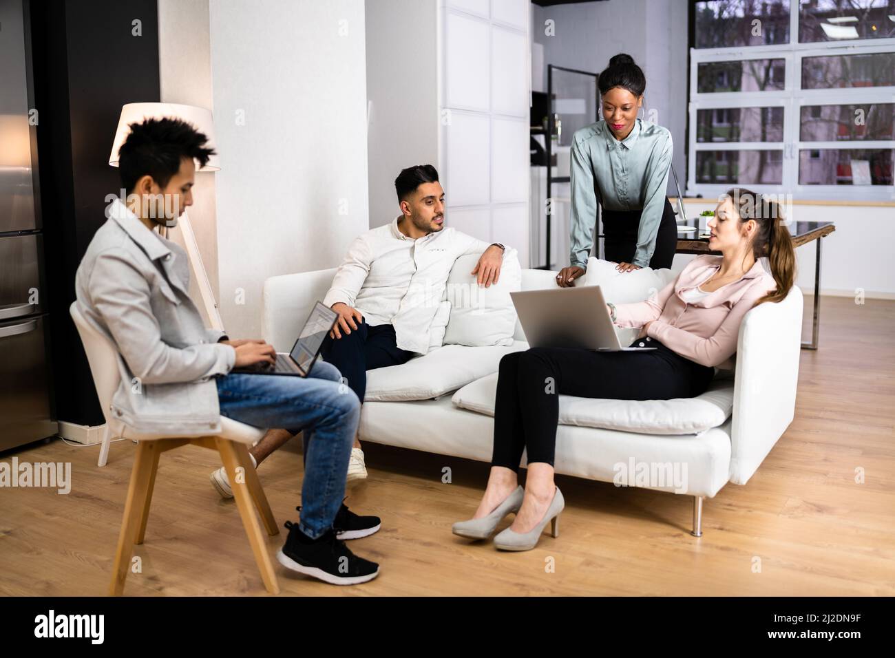 Young Diverse People Using Laptops In Coworking Space Stock Photo