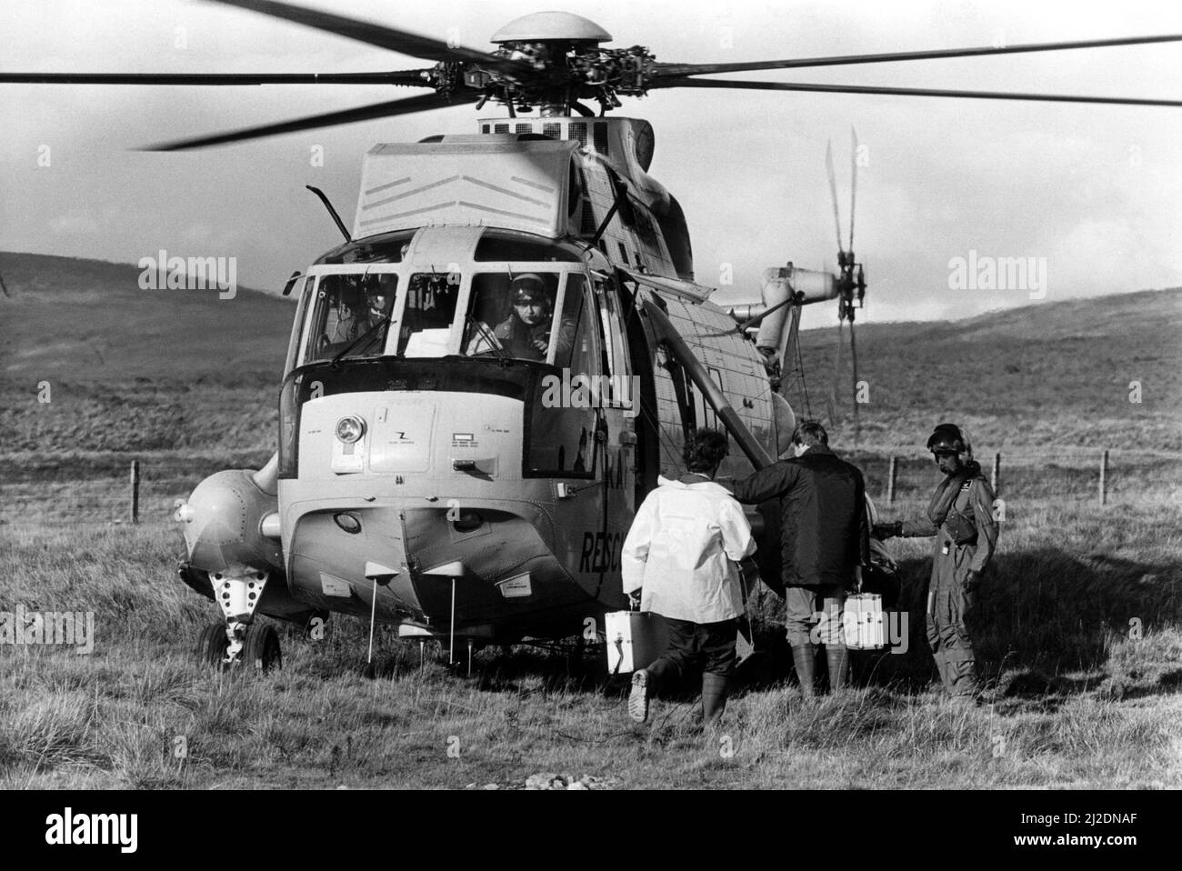 A RAF search and rescue Westland Sea King helicopter  taking police officers to an accident crash site.  Two RAF Jaguar aircraft, from RAF Coltishall, had collided in mid-air while on low flying exercise over Cumbria.   One of the pilots was killed while the other survived the accident.    07/10/1985 Stock Photo