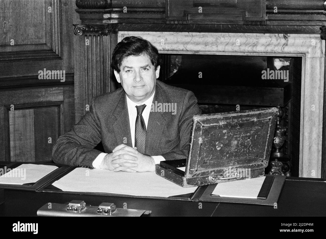Chancellor of the Exchequer Nigel Lawson at his desk with the Budget case. 11th March 1986. Stock Photo