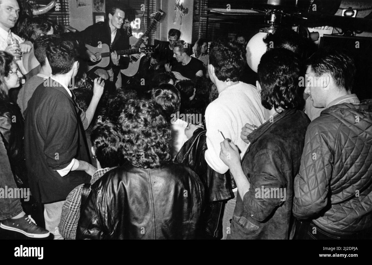 The Clash playing live inside Dukes bar in Glasgow, as part of their Busking Tour. 16th May 1985. Stock Photo