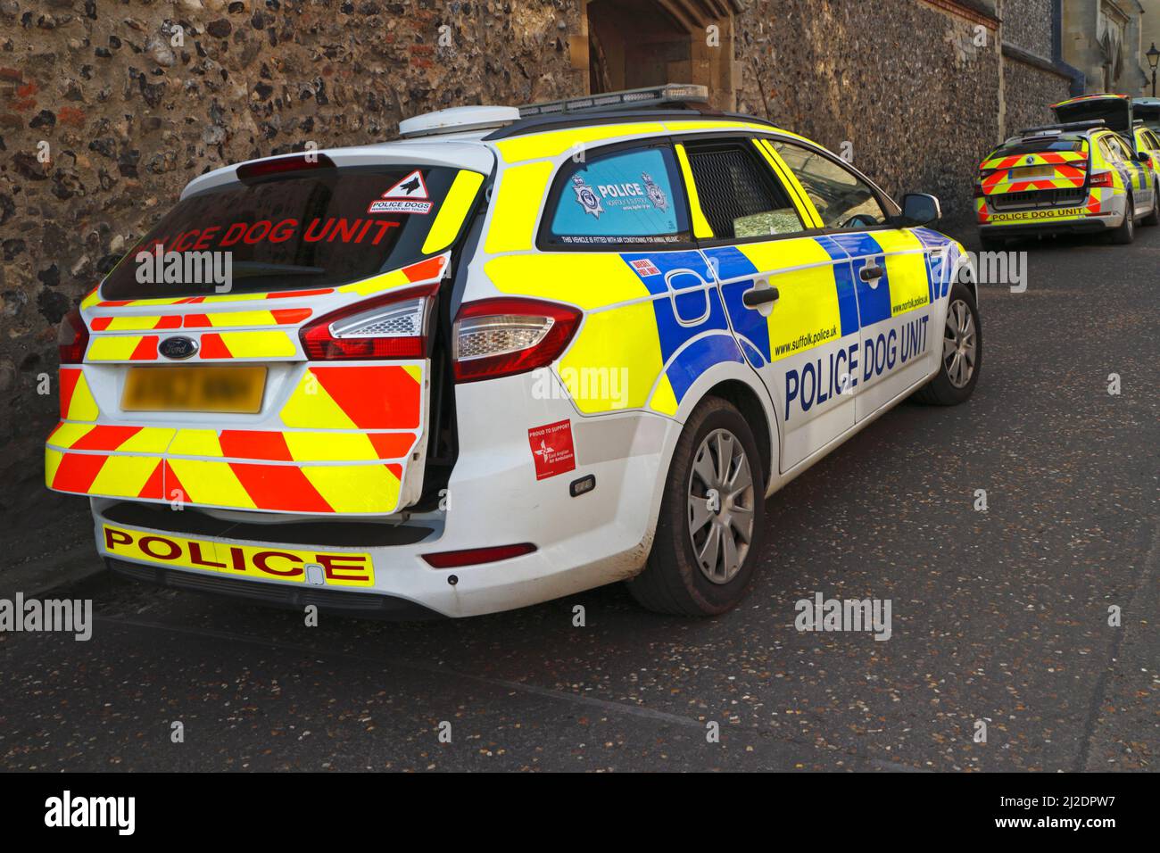 Police Dog Unit cars parked by the Cathedral in the centre of the City of Norwich, Norfolk, England, United Kingdom. Stock Photo