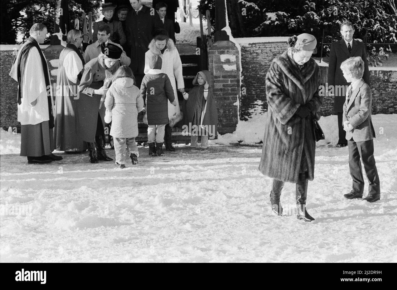 The Royal Family leave St Mary Magdalene Church, Sandringham, Norfolk, after their annual Holiday season church service. Picture shows Queen Elizabeth II, walking towards us and behind Princess Diana accepts some flowers from a young well-wisher.  This year 1985, the Christmas season has seen a healthy fall of snow.  Picture taken 29th December 1985 Stock Photo