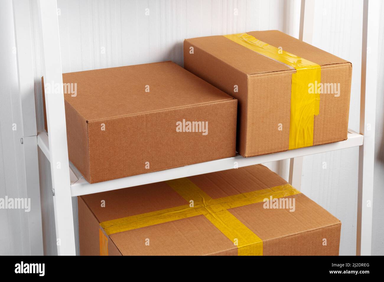 Stack of cardboard package boxes on wooden rack Stock Photo